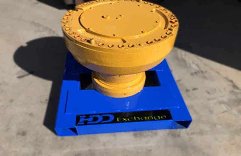A yellow and blue wheel end sitting on a concrete surface