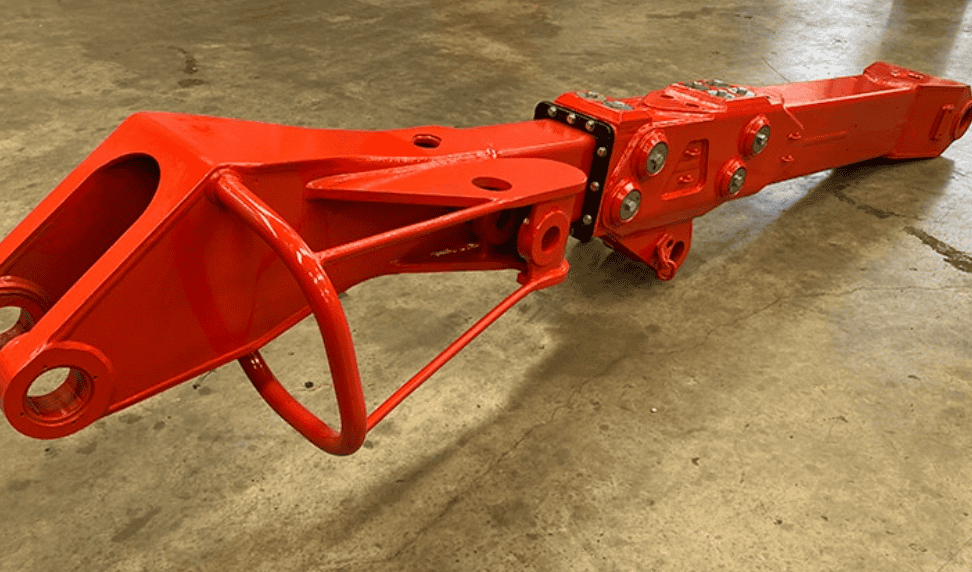 A red telescopic boom lift lying on a concrete surface